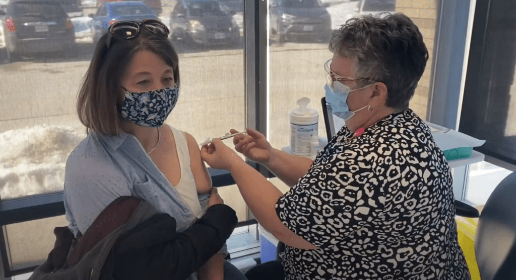 Nurse gives COVID-19 vaccine